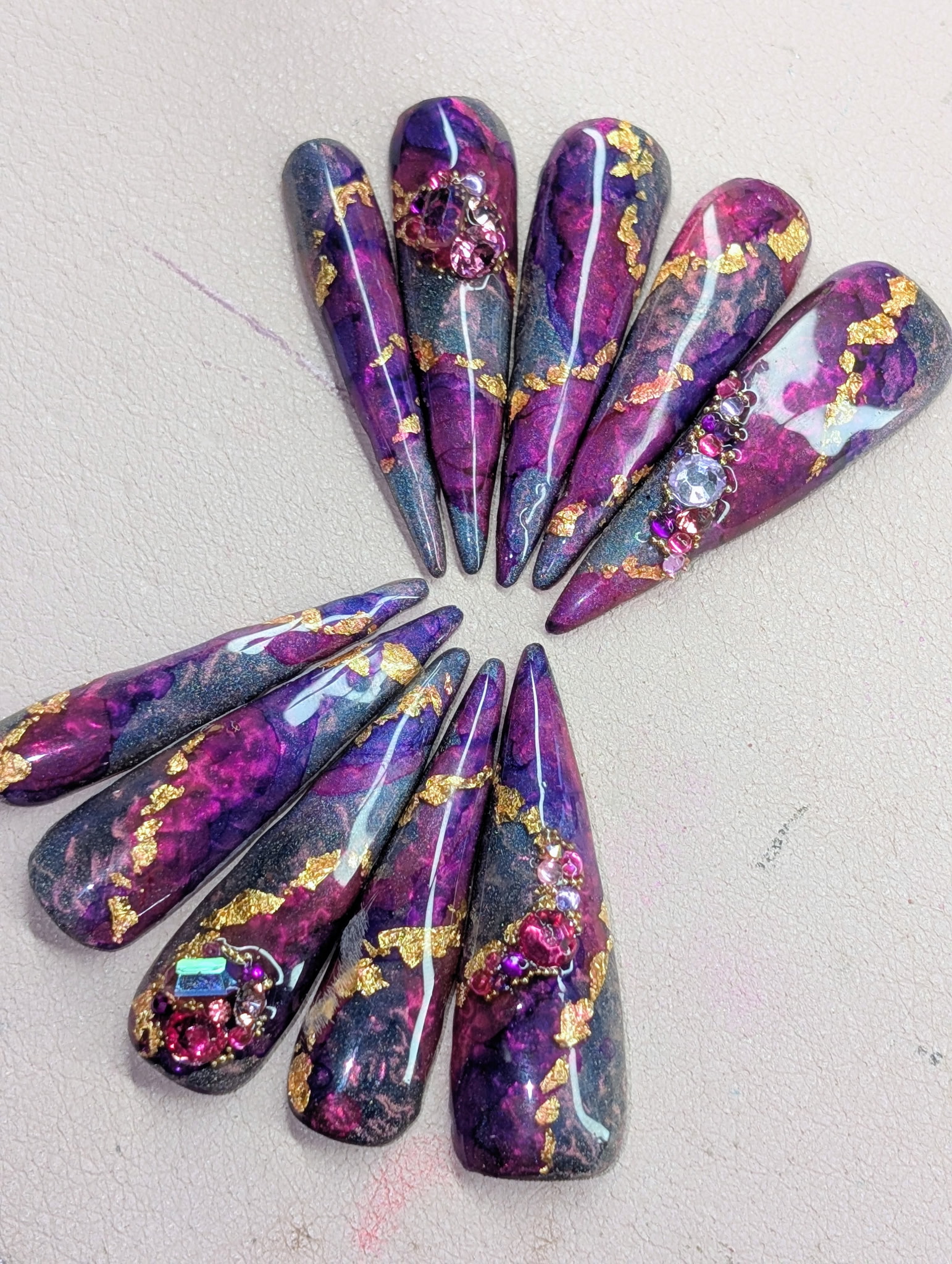 Hand wearing a Sparkle Sweatshop nail set